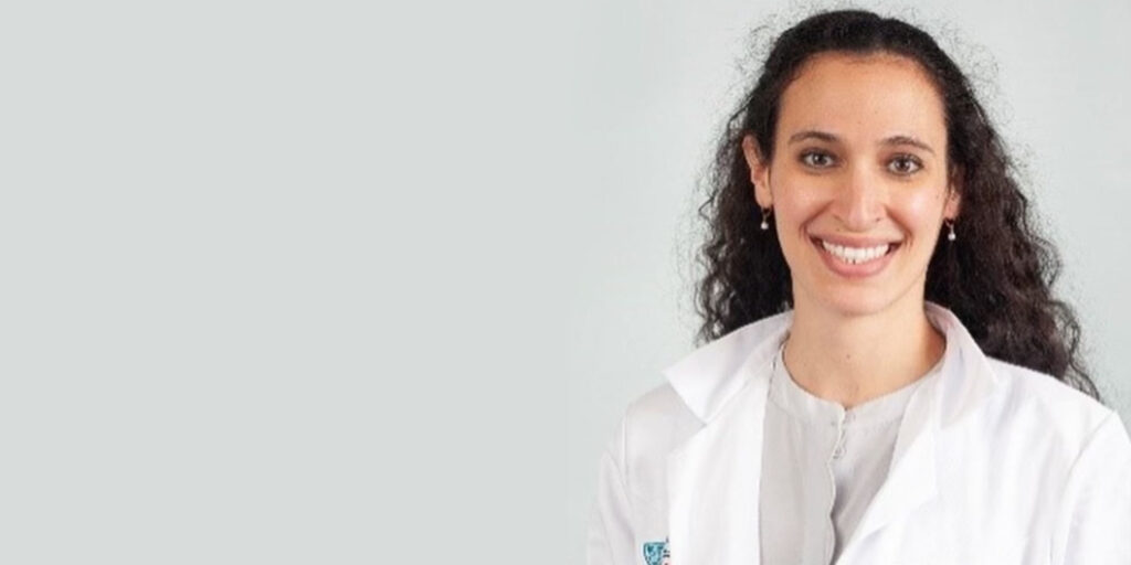 headshot of doctor smiling brightly